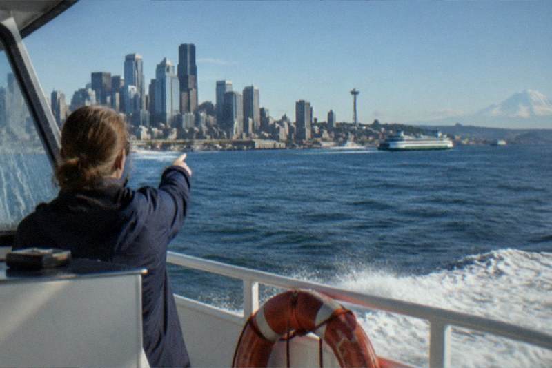 Downtown skyline from the open deck of a one-hour Argosy Cruises harbor trip; the Harbor Cruise with Local Guide listing starts at $43 per person, shows a 4.8 rating across 729 reviews and includes free cancellation.