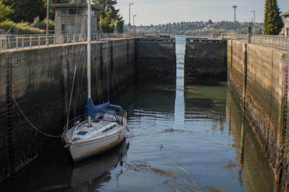 The large lock chamber at the Ballard Locks with a sailboat tied inside as water levels change