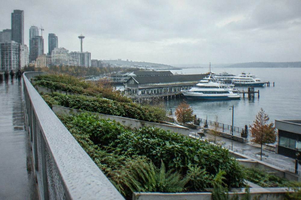 Elevated walkway and terraces above the Seattle waterfront with views over Elliott Bay and moored boats