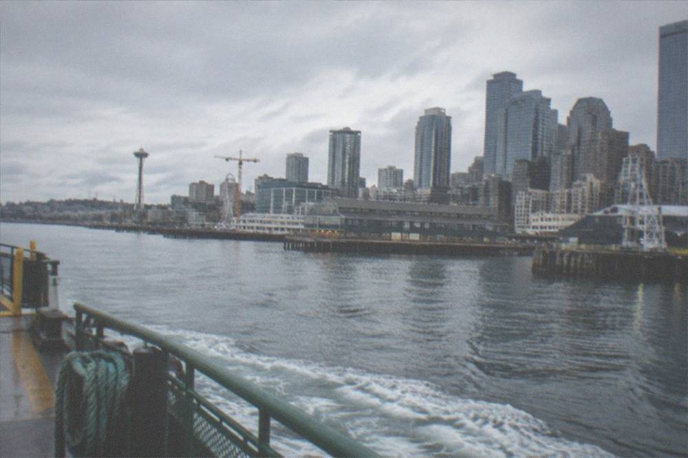 Washington State Ferry underway on Puget Sound with Seattle skyline in the distance