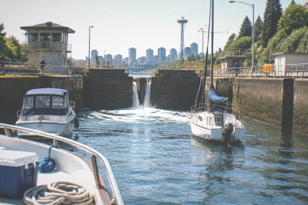 Lock gates opening at the Ballard Locks as boats wait in the ship canal