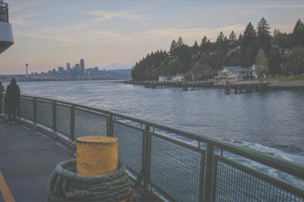 Washington State Ferry crossing Elliott Bay toward Bainbridge Island with the city behind it