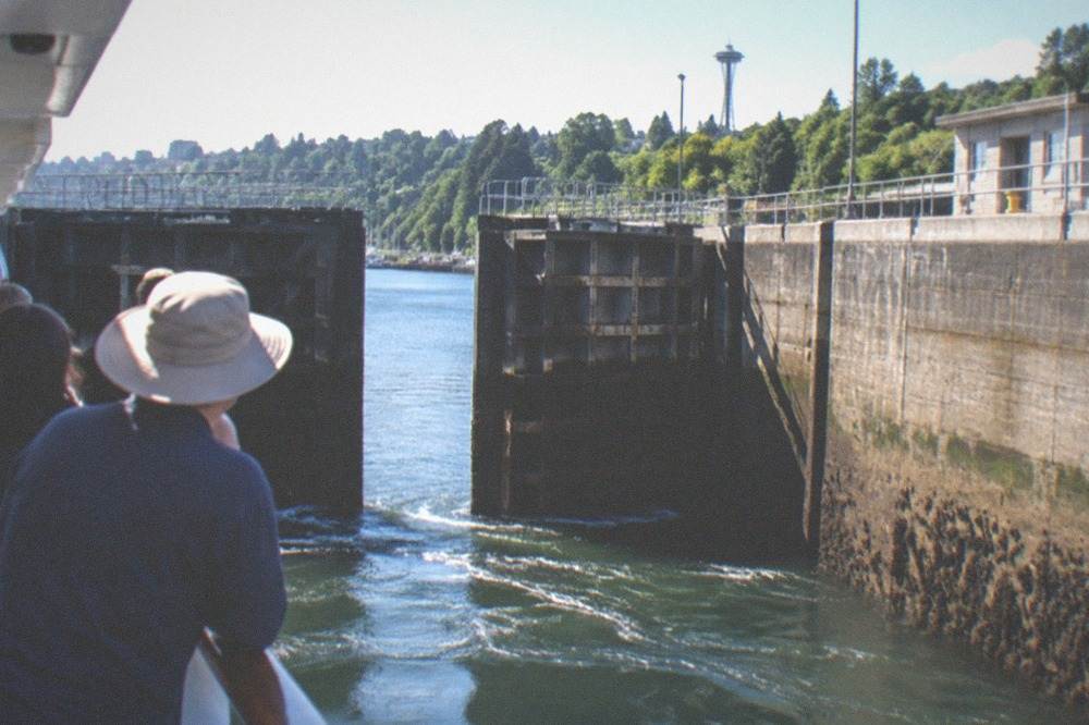 Passengers on a shared cruise watching the gates of the Ballard Locks close around the boat