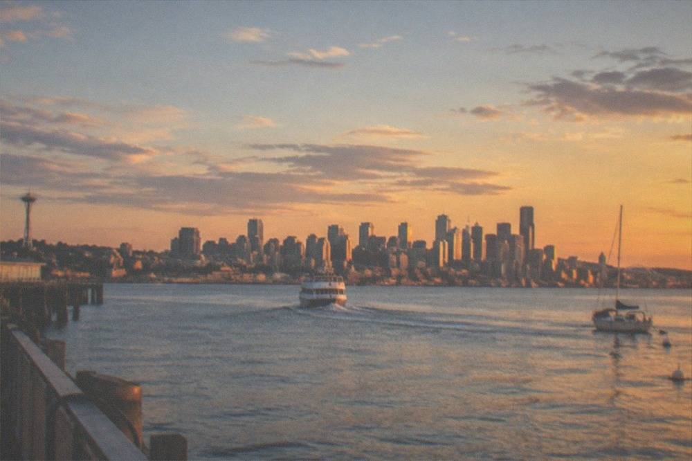 Elliott Bay in late summer with a tour boat and the skyline under a wide sky