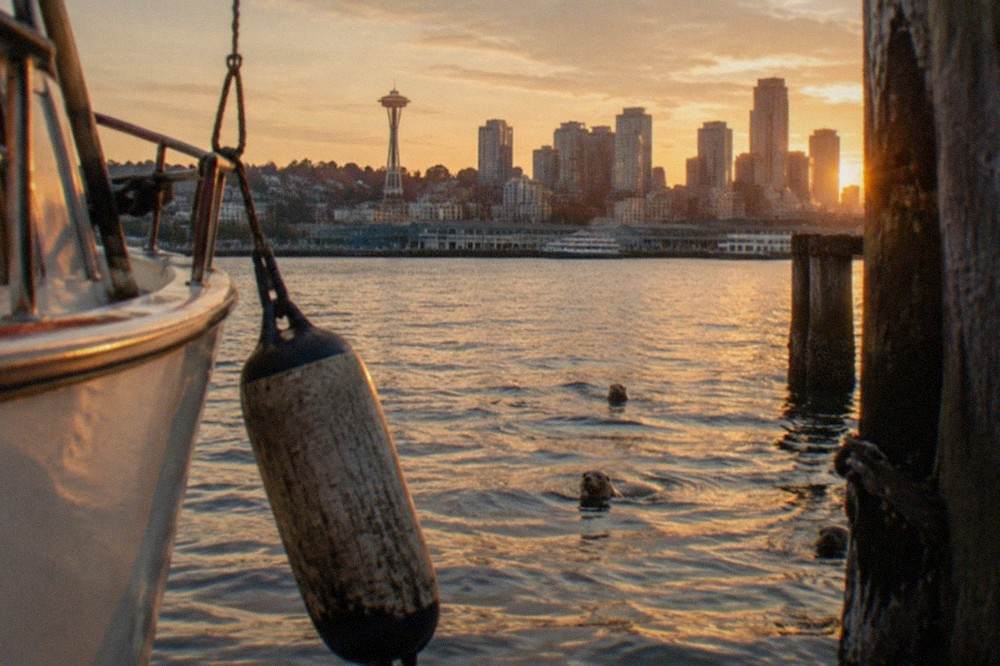 Seattle skyline in golden evening light seen from the water of Elliott Bay