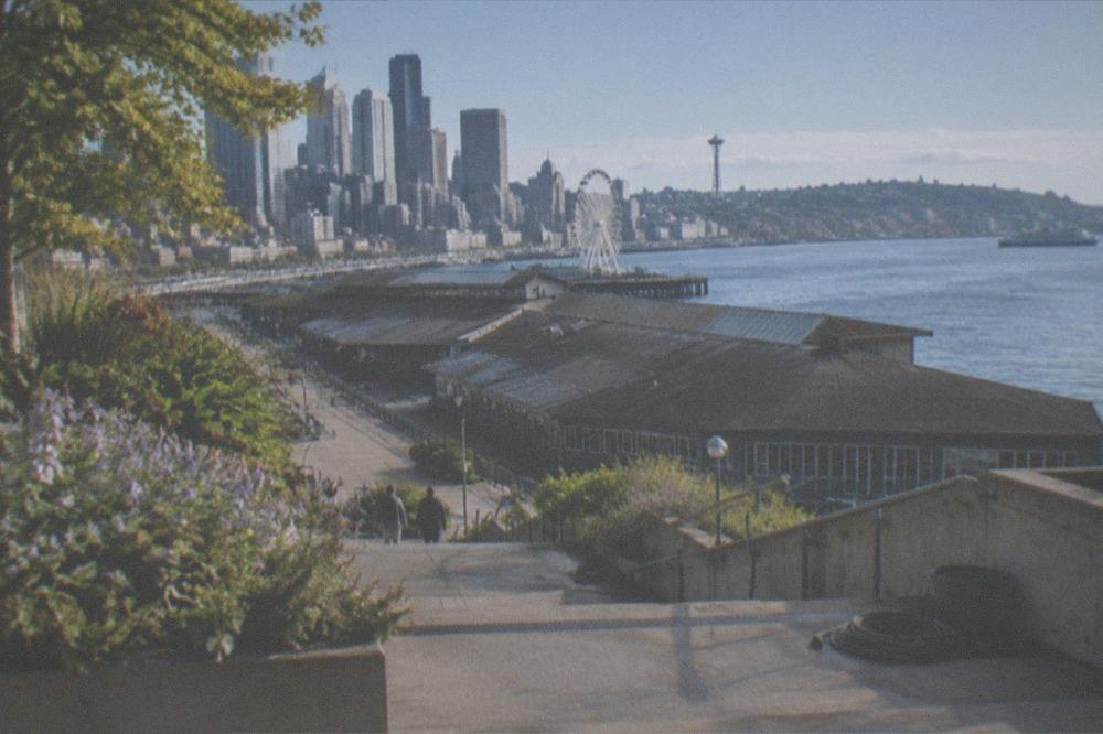 Elevated walkway with terraces descending from Pike Place Market toward Elliott Bay